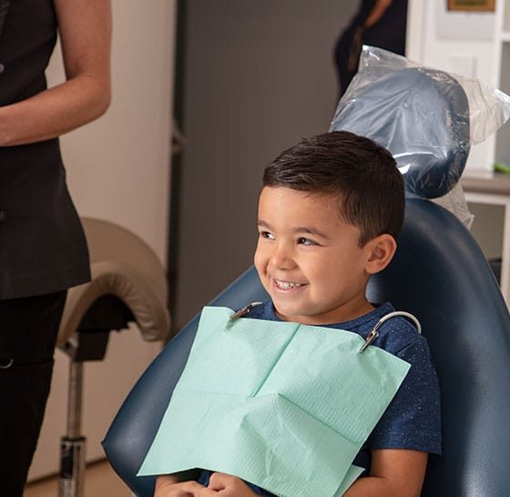 Boy Sitting On Dental Chair — Suncoastdental In Maroochydore, QLD