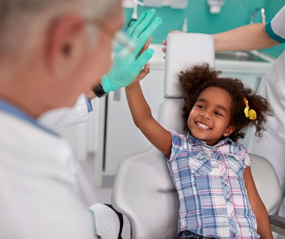 Child Giving The Dentist A High Five — Suncoastdental In Maroochydore, QLD